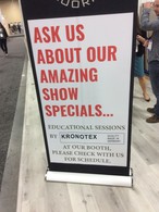 A sign announcing the installation course for KRONOTEX laminate flooring with snap-together panels on the stand of Republic Floor